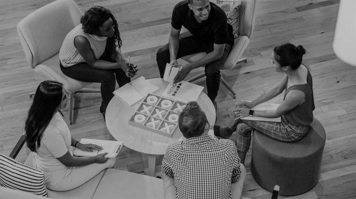 Business people sitting around a small table in conversation