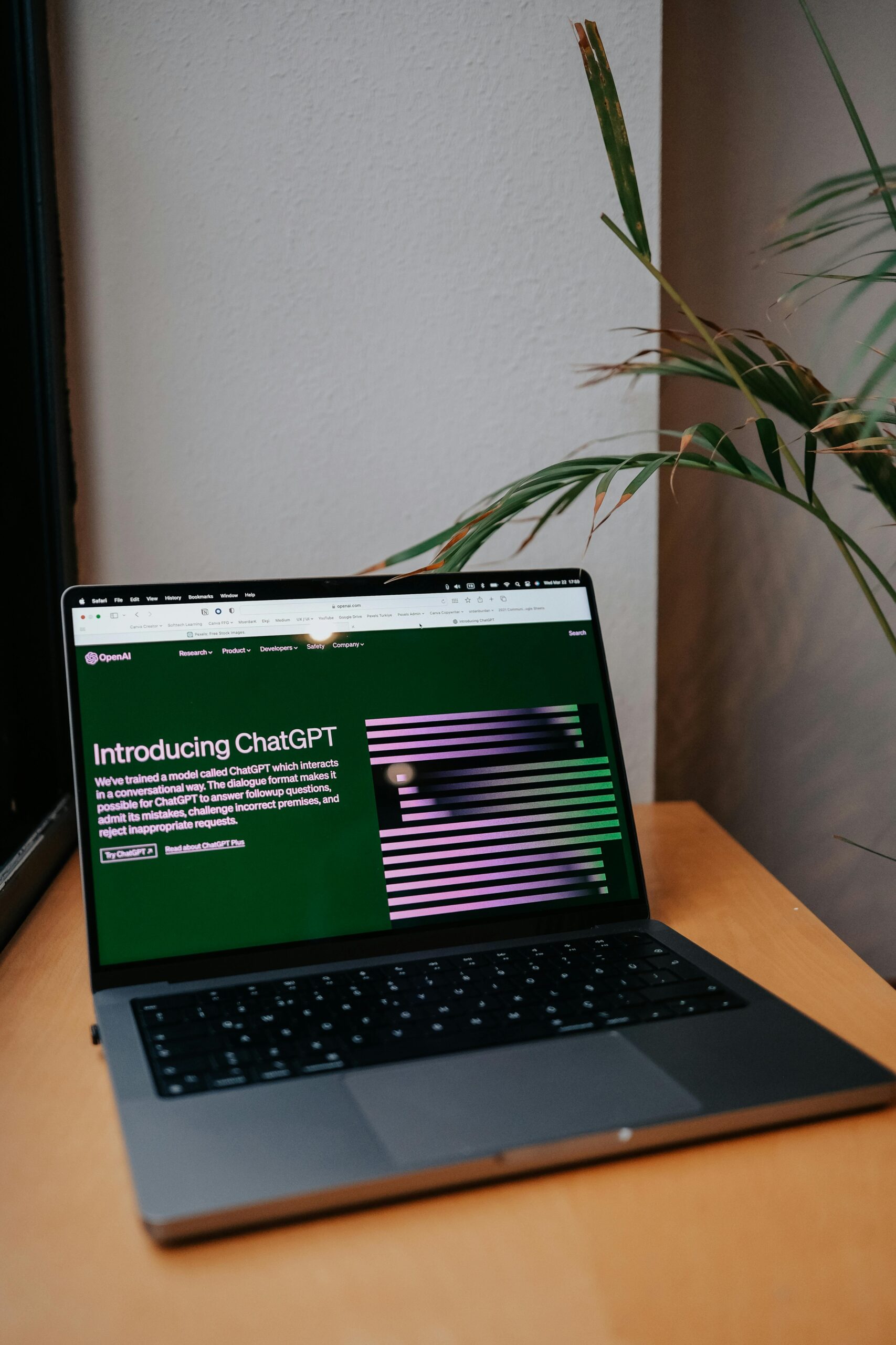 A laptop on a desk showing a ChatGPT interface, symbolizing modern AI technology in daily use.