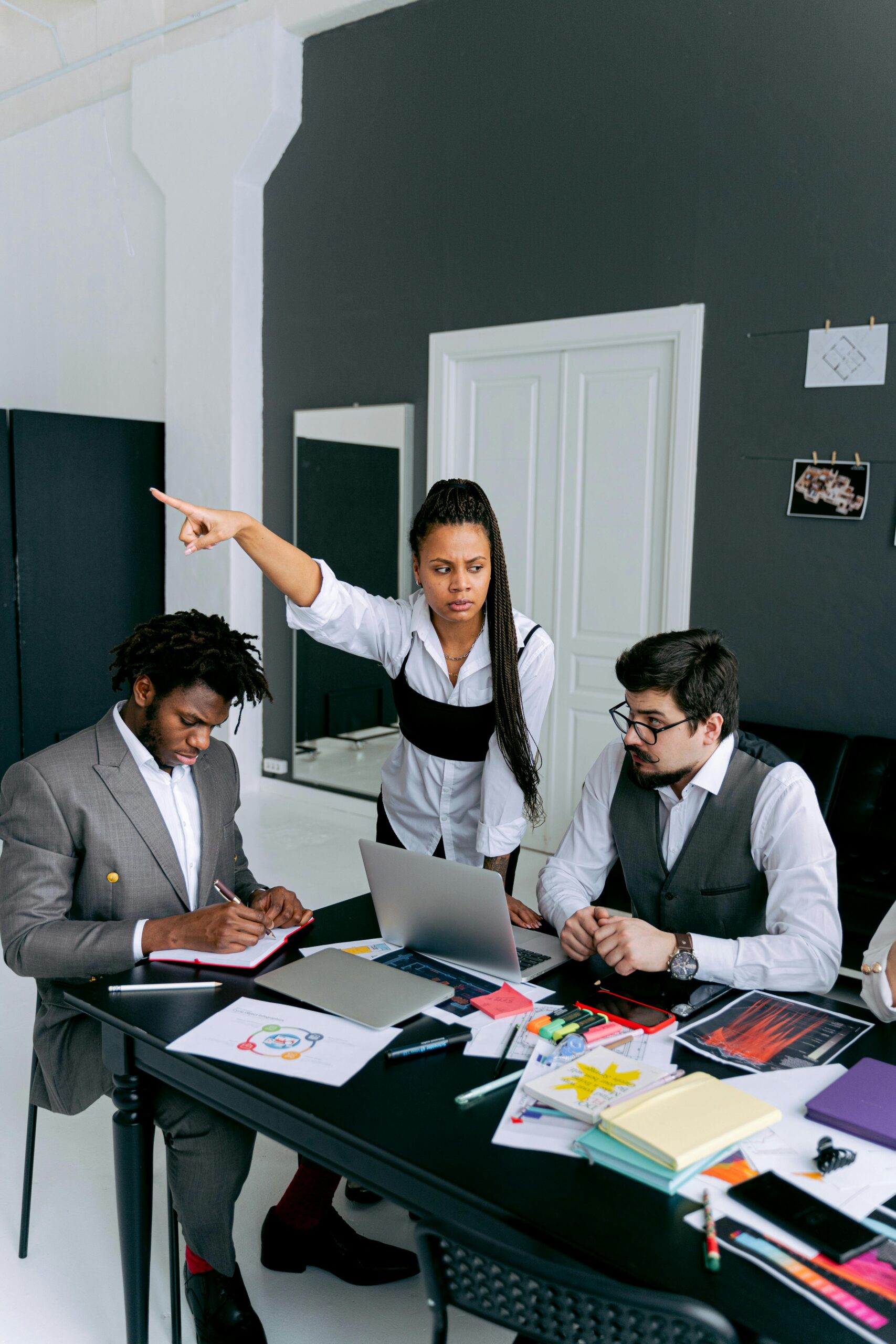 Team members in a heated discussion during a business meeting at a modern office.